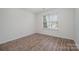 Bedroom boasting hardwood floors, a window with natural light, and neutral walls at 10130 Illoria Dr, Charlotte, NC 28273
