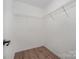 Walk-in closet with wooden floors and shelving for optimal storage at 10130 Illoria Dr, Charlotte, NC 28273