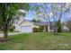 Street view of one-story home with attached garage, manicured lawn and established landscaping at 10130 Illoria Dr, Charlotte, NC 28273