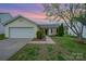 Charming one-story home with attached garage, tidy lawn and mature tree in established neighborhood at 10130 Illoria Dr, Charlotte, NC 28273