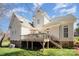 Beautiful outdoor deck with stairs and lovely views of the green lawn and blue skies above at 10502 Orchid Hill Ln, Charlotte, NC 28277