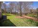 This property features a large backyard with mature trees and landscaped areas at 10502 Orchid Hill Ln, Charlotte, NC 28277