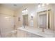 The bathroom has a double vanity with neutral countertops and tile flooring at 10502 Orchid Hill Ln, Charlotte, NC 28277