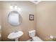 Neutral powder room featuring a pedestal sink and modern fixtures at 10502 Orchid Hill Ln, Charlotte, NC 28277
