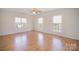 Bright and airy bedroom featuring laminate floors, three large windows and ample space at 10502 Orchid Hill Ln, Charlotte, NC 28277