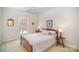 Inviting bedroom featuring a wooden bed frame, soft lighting, and a window with a view at 10502 Orchid Hill Ln, Charlotte, NC 28277