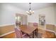 Elegant dining room showcasing hardwood floors and seamless access to living areas and kitchen at 10502 Orchid Hill Ln, Charlotte, NC 28277