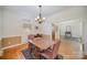 Classic dining room featuring hardwood floors, a chandelier, and beautiful natural light at 10502 Orchid Hill Ln, Charlotte, NC 28277