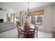 Bright dining area with large windows, chandelier and access to outdoor patio at 10502 Orchid Hill Ln, Charlotte, NC 28277