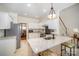 Bright kitchen with white cabinets, granite countertops, stainless steel appliances, and island seating at 10502 Orchid Hill Ln, Charlotte, NC 28277