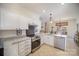 Well-lit kitchen with stainless steel appliances, granite countertops, and white cabinets at 10502 Orchid Hill Ln, Charlotte, NC 28277