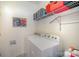 Functional laundry area with washer, dryer, and storage shelves at 10502 Orchid Hill Ln, Charlotte, NC 28277
