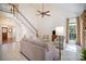 Bright living room featuring a staircase, neutral decor, and large windows for plenty of natural light at 10502 Orchid Hill Ln, Charlotte, NC 28277