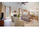 Comfortable living room featuring a fireplace, neutral furniture and plenty of natural light at 10502 Orchid Hill Ln, Charlotte, NC 28277