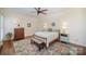 Cozy main bedroom featuring a ceiling fan, hardwood floors, and a patterned rug at 10502 Orchid Hill Ln, Charlotte, NC 28277