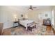 This bright main bedroom features hardwood floors, a ceiling fan, and ensuite access at 10502 Orchid Hill Ln, Charlotte, NC 28277