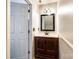 Elegant half bathroom with a stylish vanity and mirror that provides all the essentials for guests at 10961 Carmel Crossing Rd, Charlotte, NC 28226