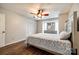 Well-lit bedroom showcasing wood-look floors, a ceiling fan and closet at 10961 Carmel Crossing Rd, Charlotte, NC 28226