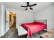 Bedroom features a ceiling fan, wood-look floors, and large bed with grey upholstered bench at 10961 Carmel Crossing Rd, Charlotte, NC 28226