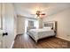 Well-lit bedroom showcasing wood-look floors, a ceiling fan and closet at 10961 Carmel Crossing Rd, Charlotte, NC 28226