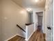 Bright hallway featuring wood floors and neutral walls leading to a bedroom and other rooms at 10961 Carmel Crossing Rd, Charlotte, NC 28226
