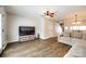 Spacious living room with comfortable seating, wood-look flooring, and lots of natural light at 10961 Carmel Crossing Rd, Charlotte, NC 28226