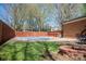 Large, fenced backyard with a covered pool, patio, and fire pit, ideal for relaxation at 119 Tara Ter, Kings Mountain, NC 28086