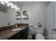 Bathroom with dark vanity, granite countertop, and decorative shelving at 119 Tara Ter, Kings Mountain, NC 28086
