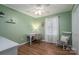 Bedroom featuring green walls, a desk, and a rocking chair with natural light at 119 Tara Ter, Kings Mountain, NC 28086