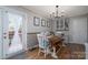 Bright dining room with wood floors, stylish light fixture, and access to outdoor deck at 119 Tara Ter, Kings Mountain, NC 28086