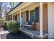 Cozy covered front porch featuring brick details, a bench, and decorative accents at 119 Tara Ter, Kings Mountain, NC 28086