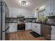 Modern kitchen featuring white cabinets, stainless steel appliances, and hardwood flooring at 119 Tara Ter, Kings Mountain, NC 28086