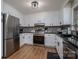 Kitchen featuring white cabinets, stainless steel appliances, and hardwood flooring at 119 Tara Ter, Kings Mountain, NC 28086