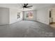 Carpeted bedroom with a ceiling fan and natural light from two large windows at 1326 Dunmore Ct, Clover, SC 29710