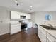 Clean kitchen featuring white cabinetry, stainless steel appliances, and dark hardwood floors at 1326 Dunmore Ct, Clover, SC 29710