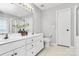 Bright bathroom with double vanity, tiled floors, and glass-enclosed shower at 13930 Thompson Rd, Mint Hill, NC 28227