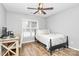 Bedroom featuring a ceiling fan, natural light from the window, wooden floors, desk and a comfortable bed at 13930 Thompson Rd, Mint Hill, NC 28227