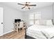 Bedroom featuring a ceiling fan, natural light from the window, wooden floors, desk and a comfortable bed at 13930 Thompson Rd, Mint Hill, NC 28227