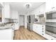 Modern kitchen with stainless steel appliances and white cabinets at 13930 Thompson Rd, Mint Hill, NC 28227