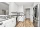 Well-lit kitchen with stainless steel appliances and white cabinets at 13930 Thompson Rd, Mint Hill, NC 28227