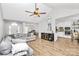 Open-concept living room with hardwood floors, a vaulted ceiling, and a cozy gray sofa at 13930 Thompson Rd, Mint Hill, NC 28227