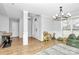 An open-concept entryway adjacent to the bright dining room with modern light fixtures at 13930 Thompson Rd, Mint Hill, NC 28227