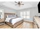 Comfortable bedroom with tray ceiling, fan, large window, and wooden furniture at 13930 Thompson Rd, Mint Hill, NC 28227