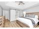 Comfortable bedroom with tray ceiling, fan, large window, and wooden furniture at 13930 Thompson Rd, Mint Hill, NC 28227