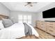Comfortable bedroom with tray ceiling, fan, large window, and wooden furniture at 13930 Thompson Rd, Mint Hill, NC 28227