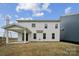 Exterior backyard showcasing a covered patio and ample green space, perfect for outdoor activities at 1439 Hubert Graham Way, Tega Cay, SC 29708