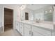 Bathroom features double sinks, white cabinets, and views into the walk-in closet at 1439 Hubert Graham Way, Tega Cay, SC 29708