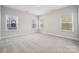Bedroom with carpet, natural light, and two windows overlooking the street at 1439 Hubert Graham Way, Tega Cay, SC 29708