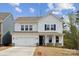 Charming two-story home boasts white siding, dark shutters, and a welcoming two-car garage at 1439 Hubert Graham Way, Tega Cay, SC 29708