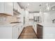 Well-equipped kitchen with stainless steel appliances, a large island, and elegant white cabinetry at 1439 Hubert Graham Way, Tega Cay, SC 29708